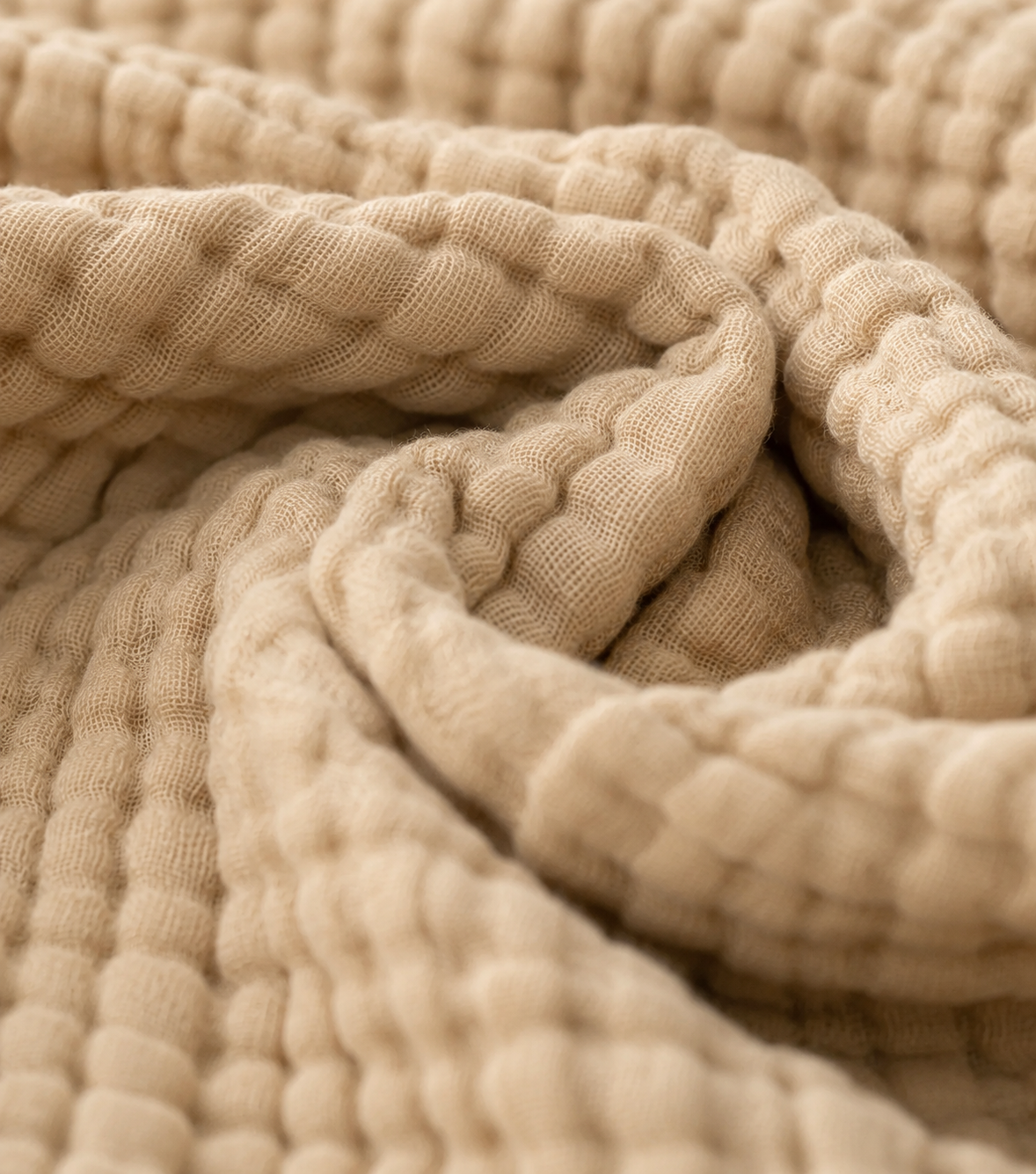 Muslin cotton blanket in oatmeal, styled